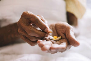 pills in a Senior's hands